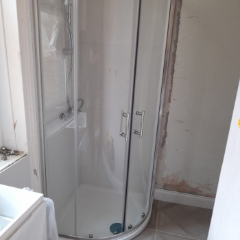 Connecting the toilet, sink and shower to the drain pipe.