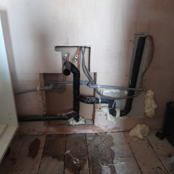 Setting up the drainage and pipes to bring water to the new kitchen.